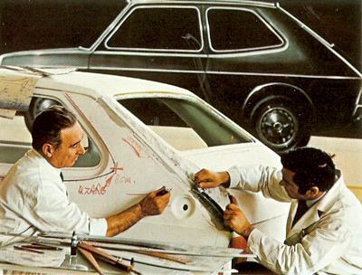Designers re-shaping a prototype of the Fiat 127 with plaster